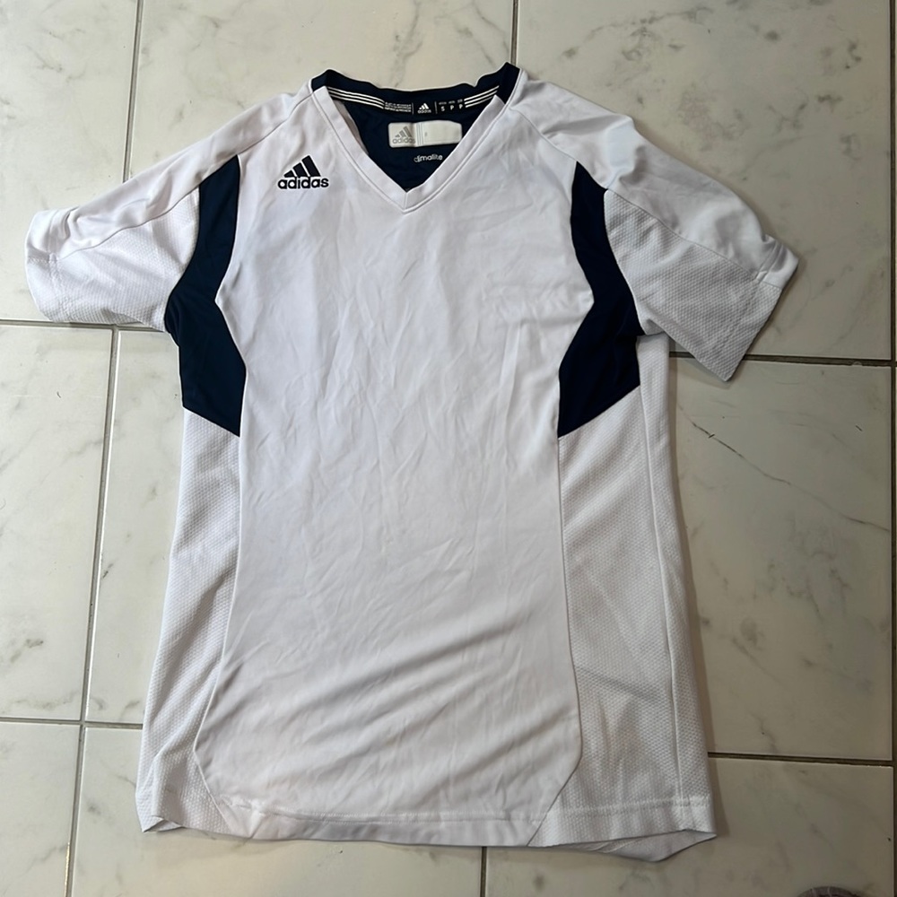 White and navy blue adidas golf shirt.